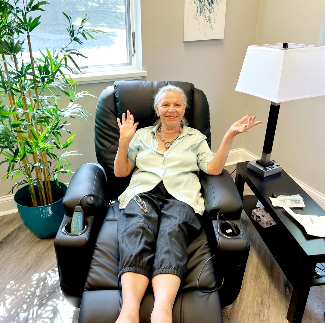 Smiling patient relaxing in a massage recliner during her infusion at Infuse One Ohio